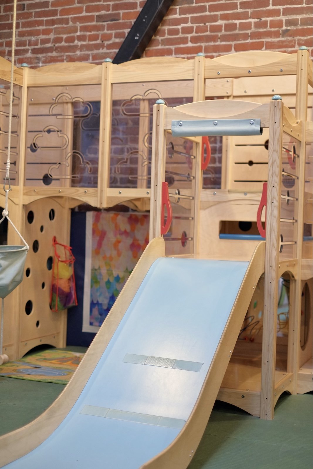 Close-up of the wooden climbing tower and slide in the play room