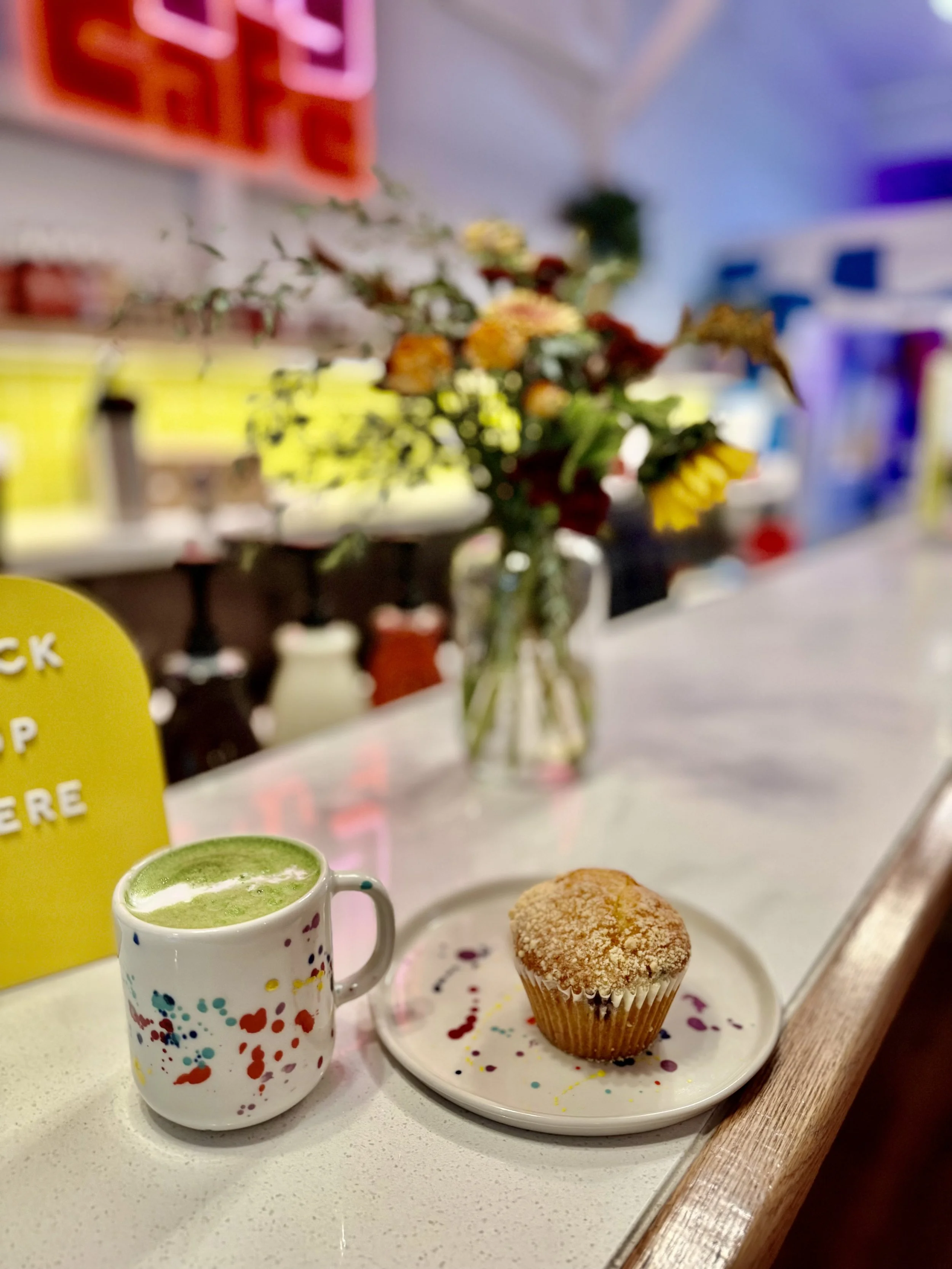 Matcha latte and muffin at the bar at Art Play Café