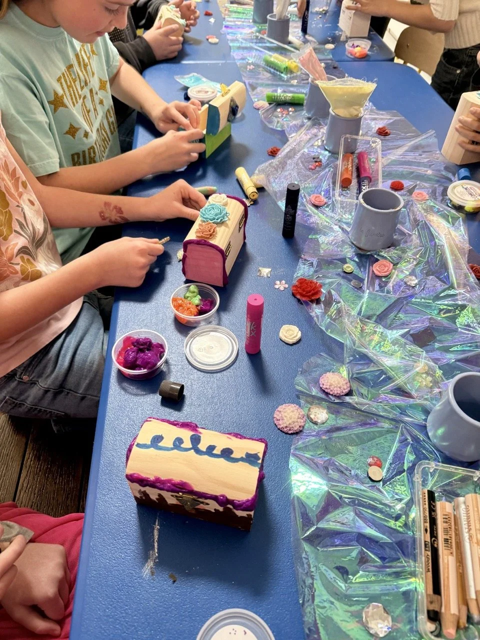 Kids decorating boxes as a birthday party craft activity