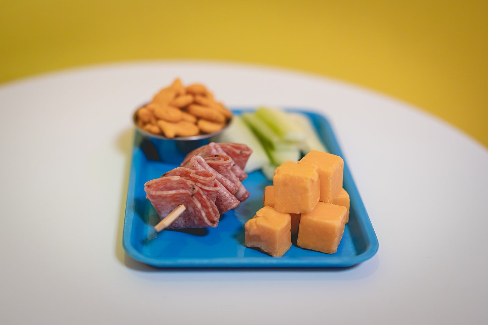 Munchable plate with cheese, fruit, and snacks at Art Play Café
