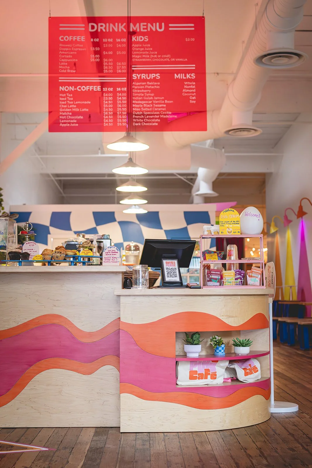 Checkout counter with menu board and Art Play Café merchandise shelf