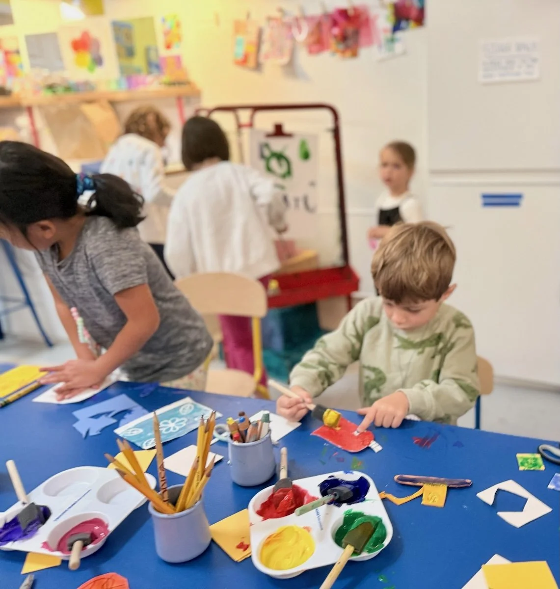Kids painting during a studio art class at Art Play Café.