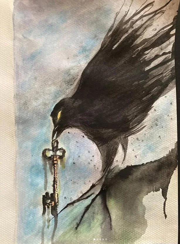 Keeper of Secrets. An expressive watercolor painting of a black crow in profile, holding a large, ornate skeleton key in its beak. The bird's feathers are rendered with loose, sweeping brushstrokes that trail off into ink splatters, suggesting moveme