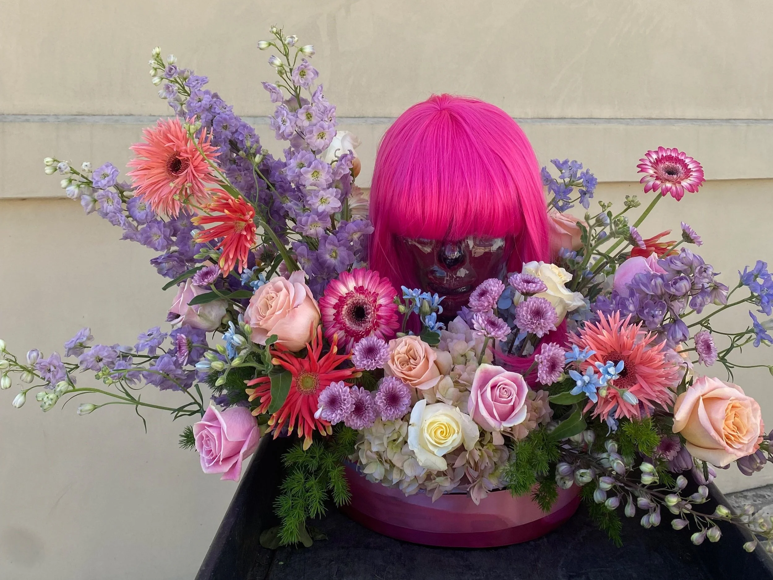 A fun custom piece with a glass statue in the middle of the arrangment!