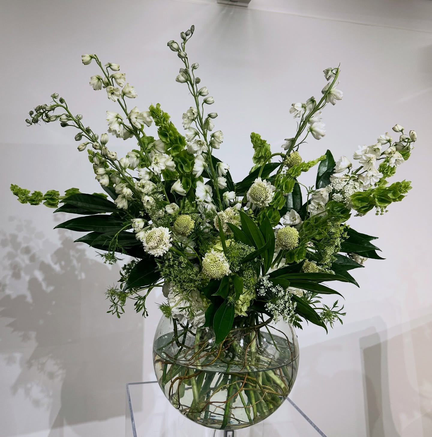A grounded green and white palette with natural movement and texture for Wellness in Design at Atlanta Decorative Arts Center. #ADAC #Interiordesign #floraldesign #atlflorist