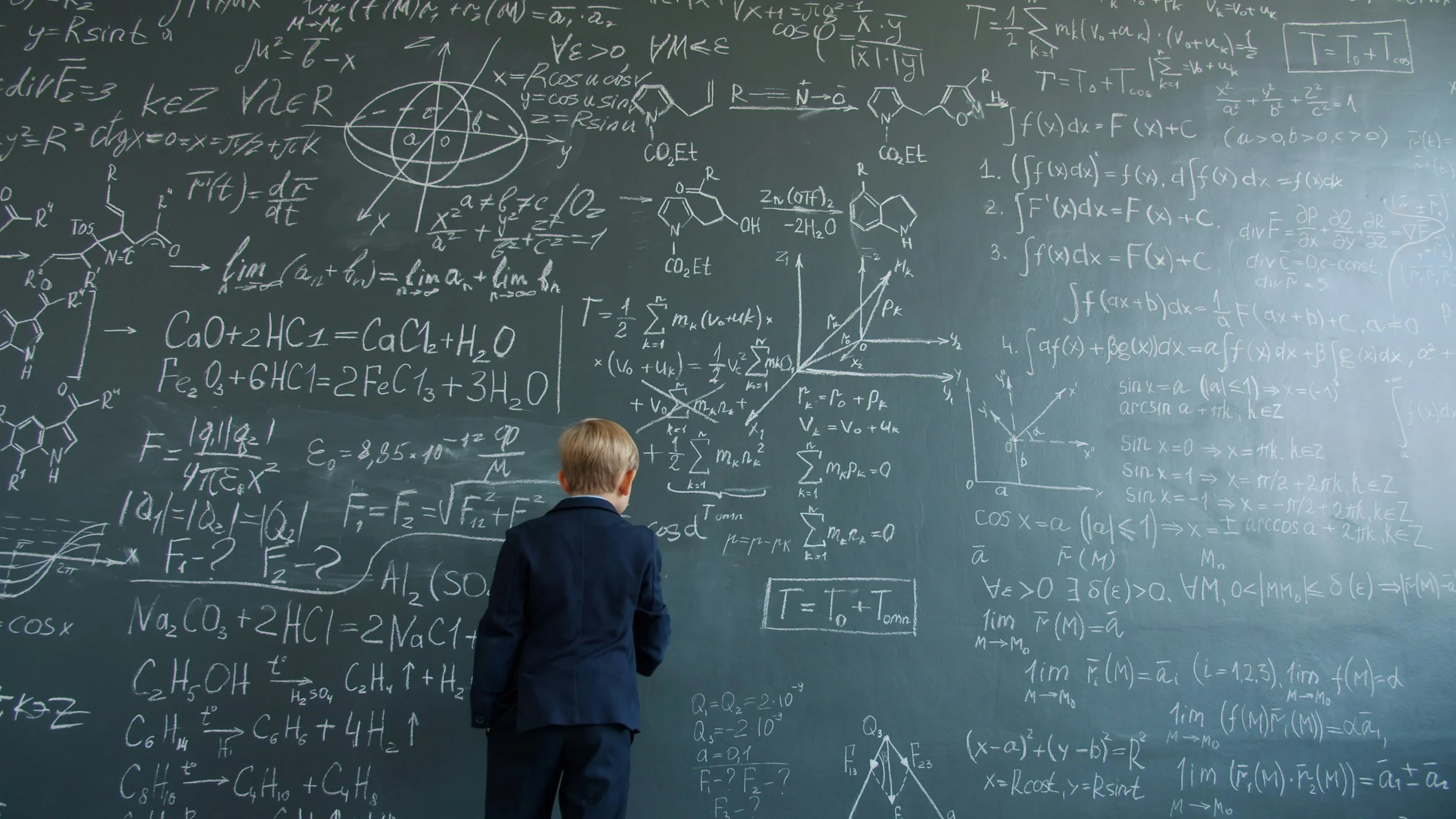 Young man doing complex math and chemistry formulas, graphs, and diagrams.