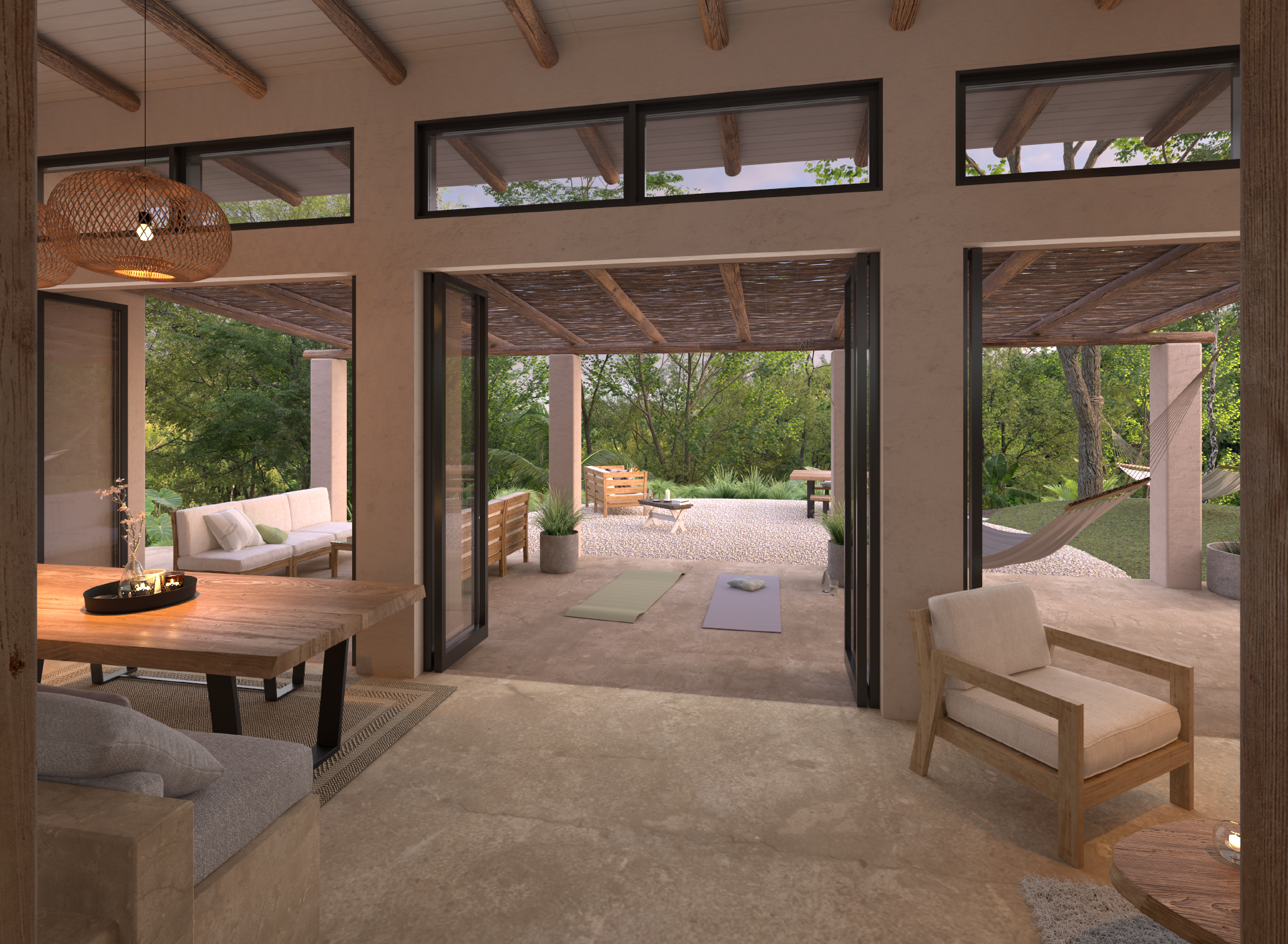 View of a veranda with yoga mats, comfortable seating, potted plants, and a hammock, overlooking a lush green garden.