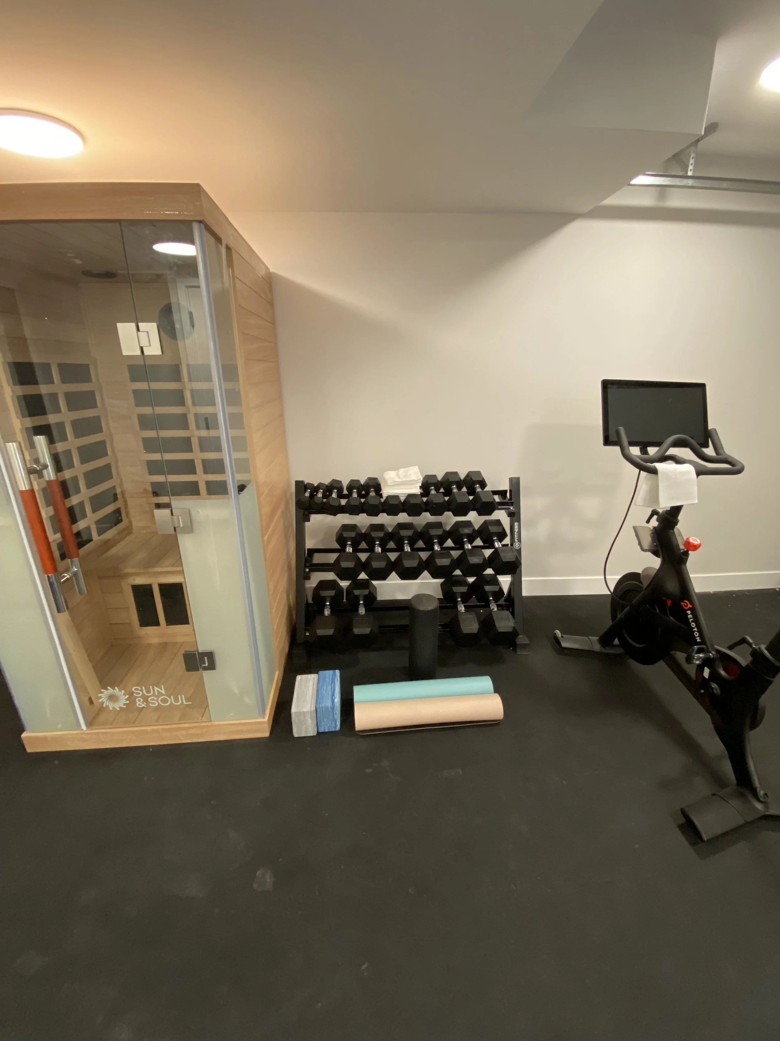 Garage has been converted to a practical gym and entryway space. We added rubber gym flooring which is great for working out but also acts as a great landing space when coming in from skiing. Gym features a Peloton bike, weights up to 50 lbs, yoga ma