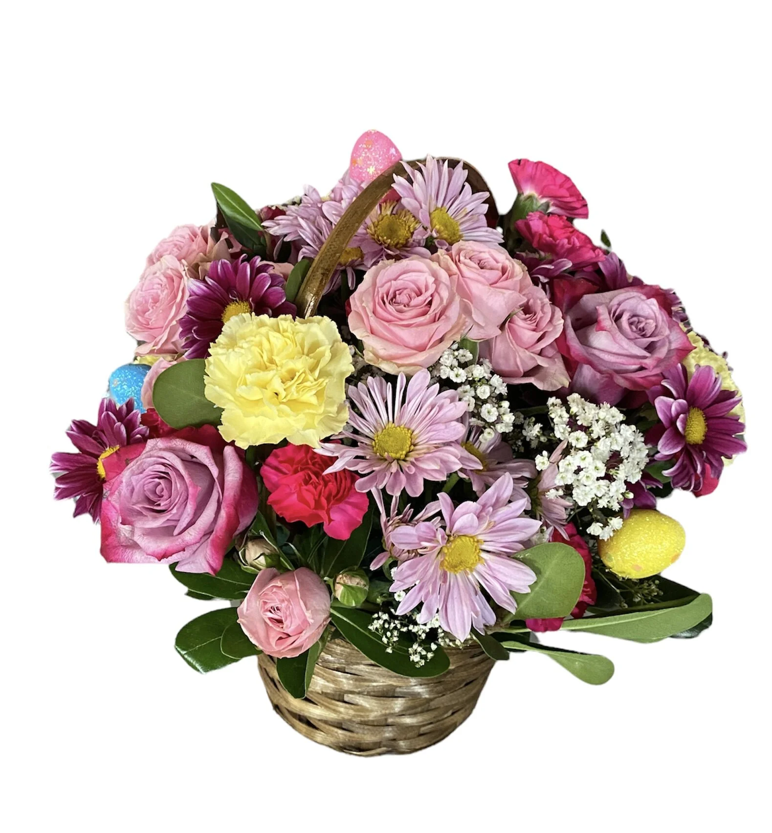 Spring colored flowers in a basket with Easter Eggs