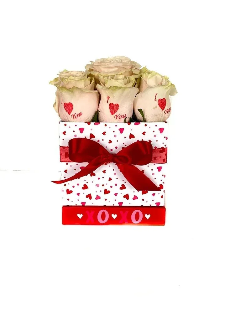 Light pink roses with red hearts in a white hat box with red hearts