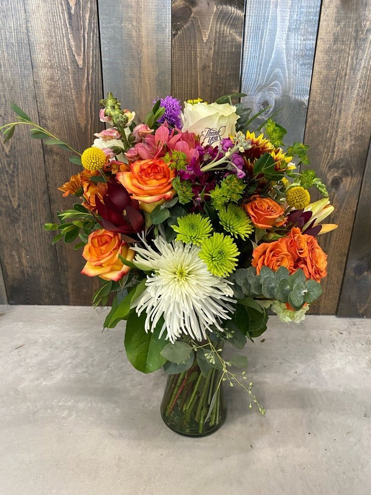 Orange and burgundy flowers in a vase