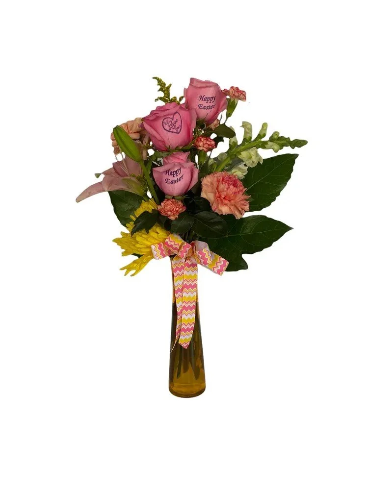 Three pink roses in a purple vase with a bow