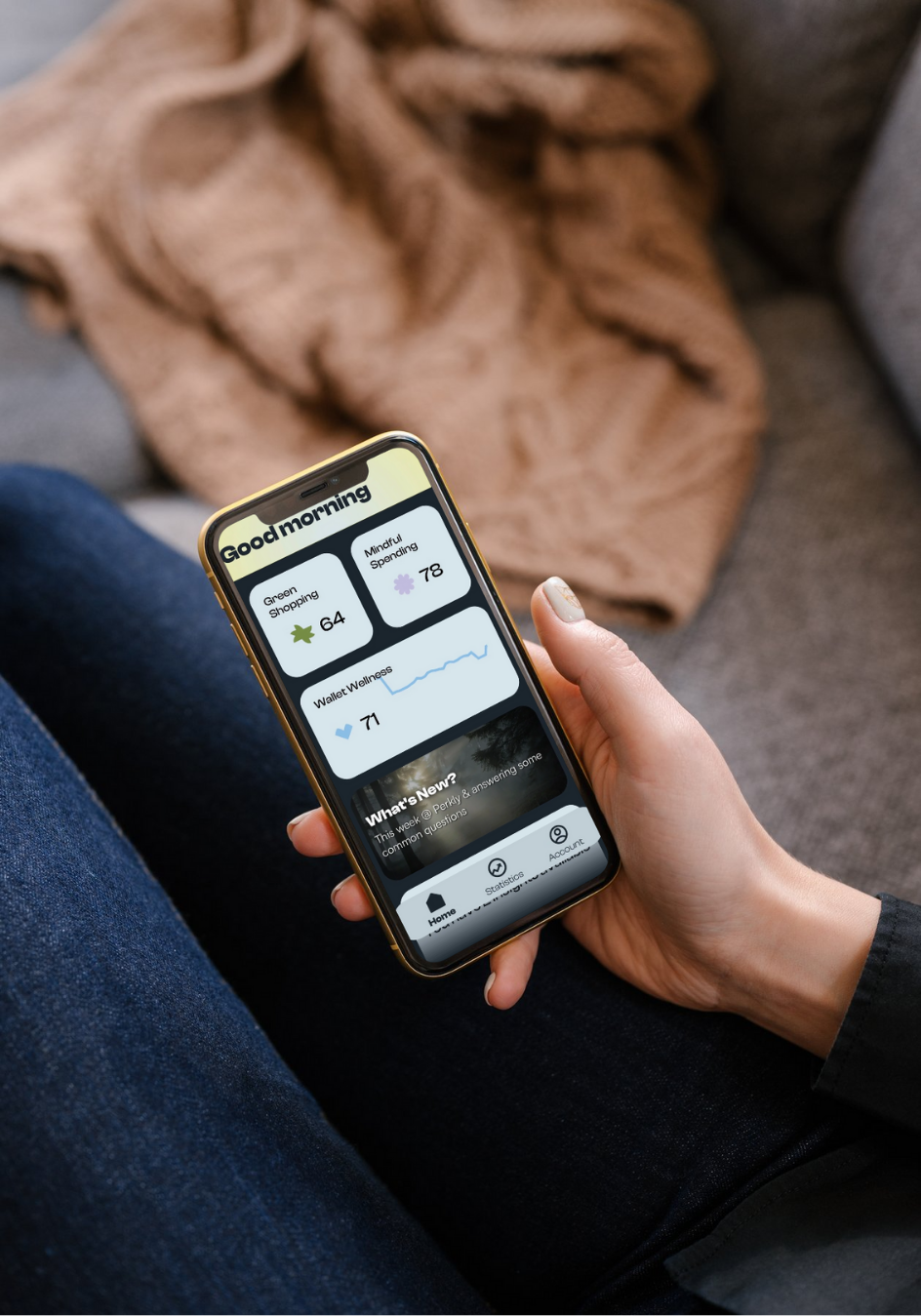 A hand holding phone displaying Perkly spending scores