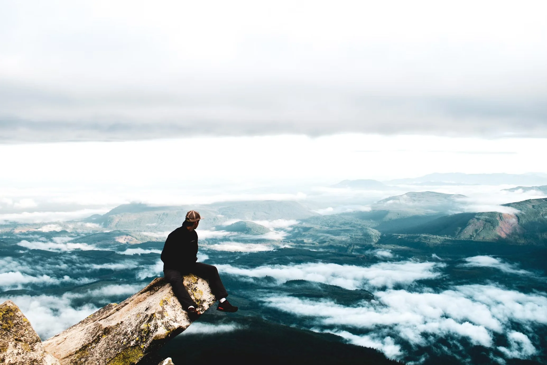 Man standing on top of mountain, looking to the future