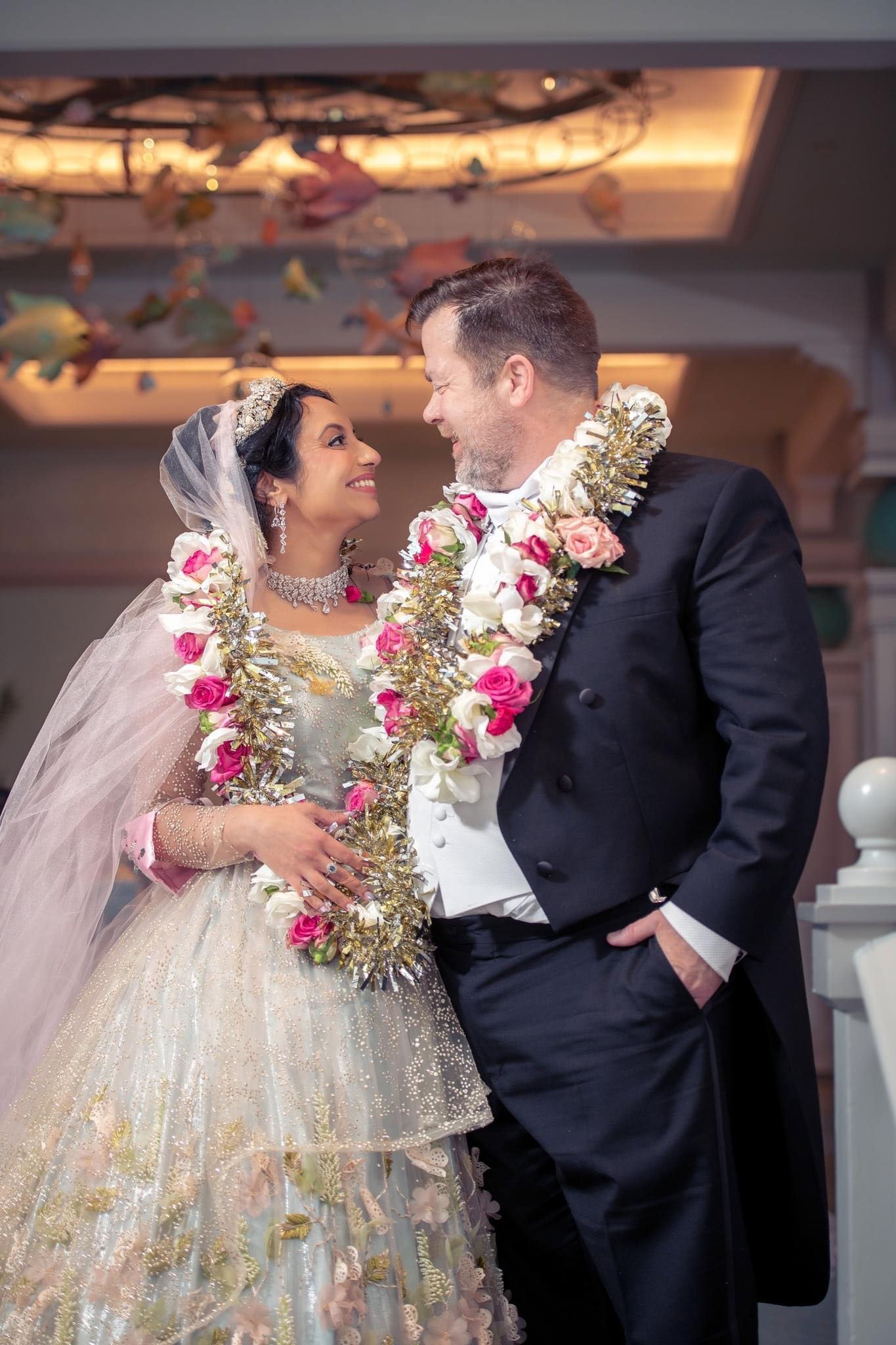 Photo by DeShawna Willis - Walt Disney Wedding photographer - Central Florida - indian wedding - pink indian leis - Ariel's reception at Beach Club - disney fine art photography - pink green indian wedding dress