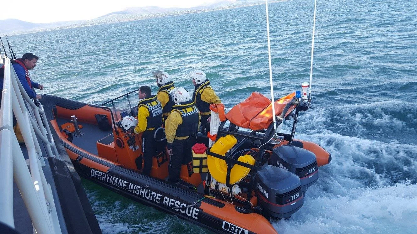 The RIB from the rescue Team next to another vessel at sea with 4 crew