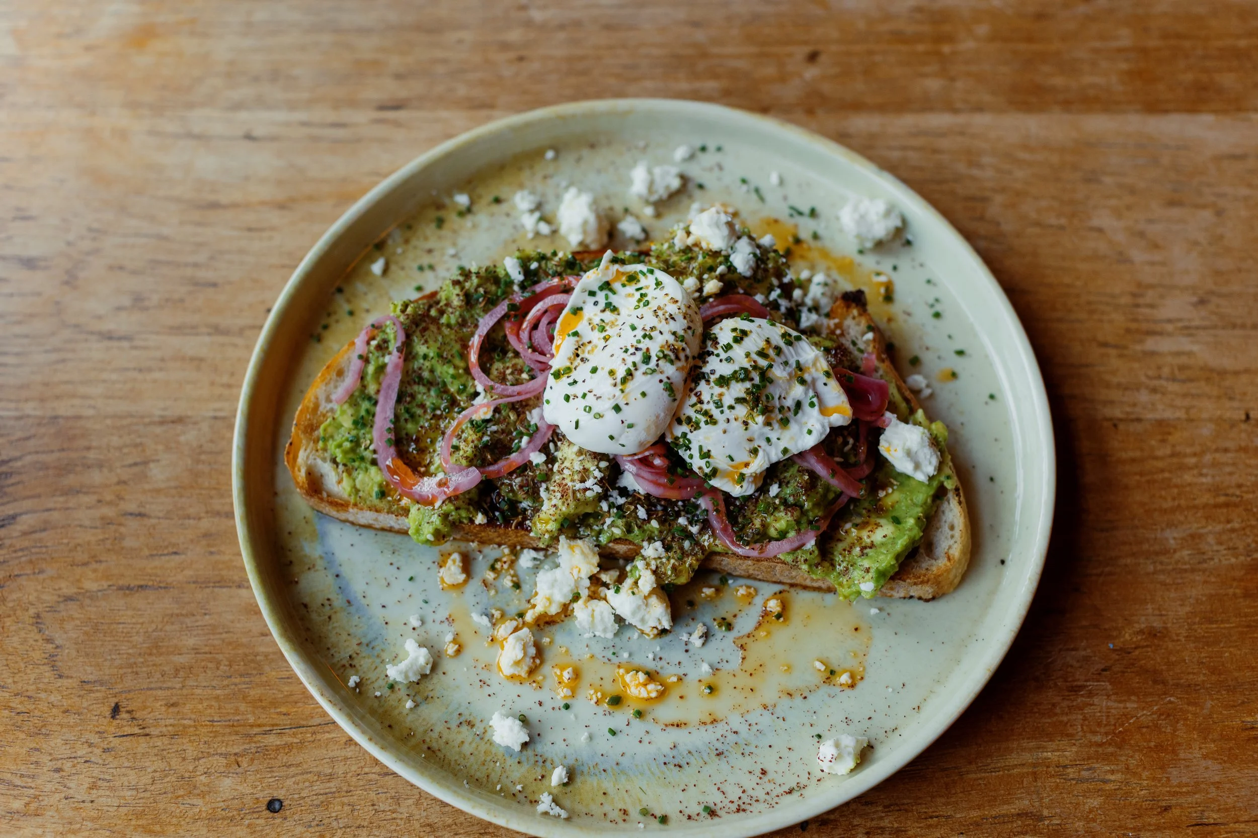 Smashed avocado, poached eggs, crumbled feta on sourdough toast at Wallop