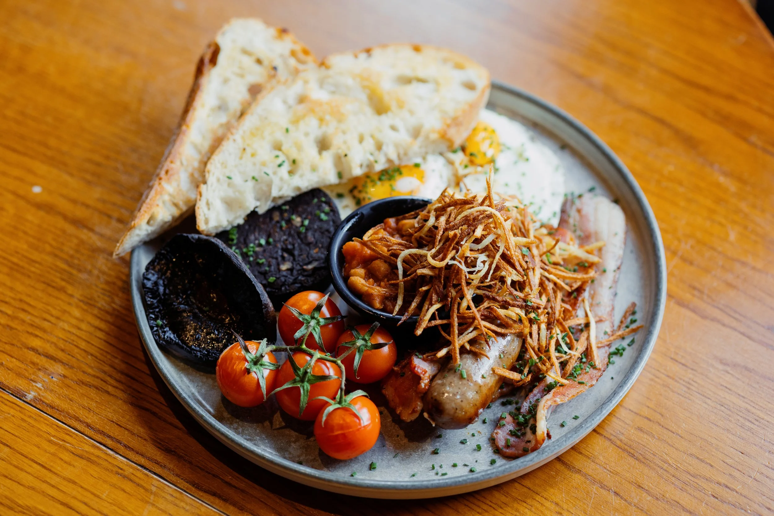 Sausage, bacon, roasted vine tomatoes, Bury black pudding, fried eggs and sourdough toast at Wallop