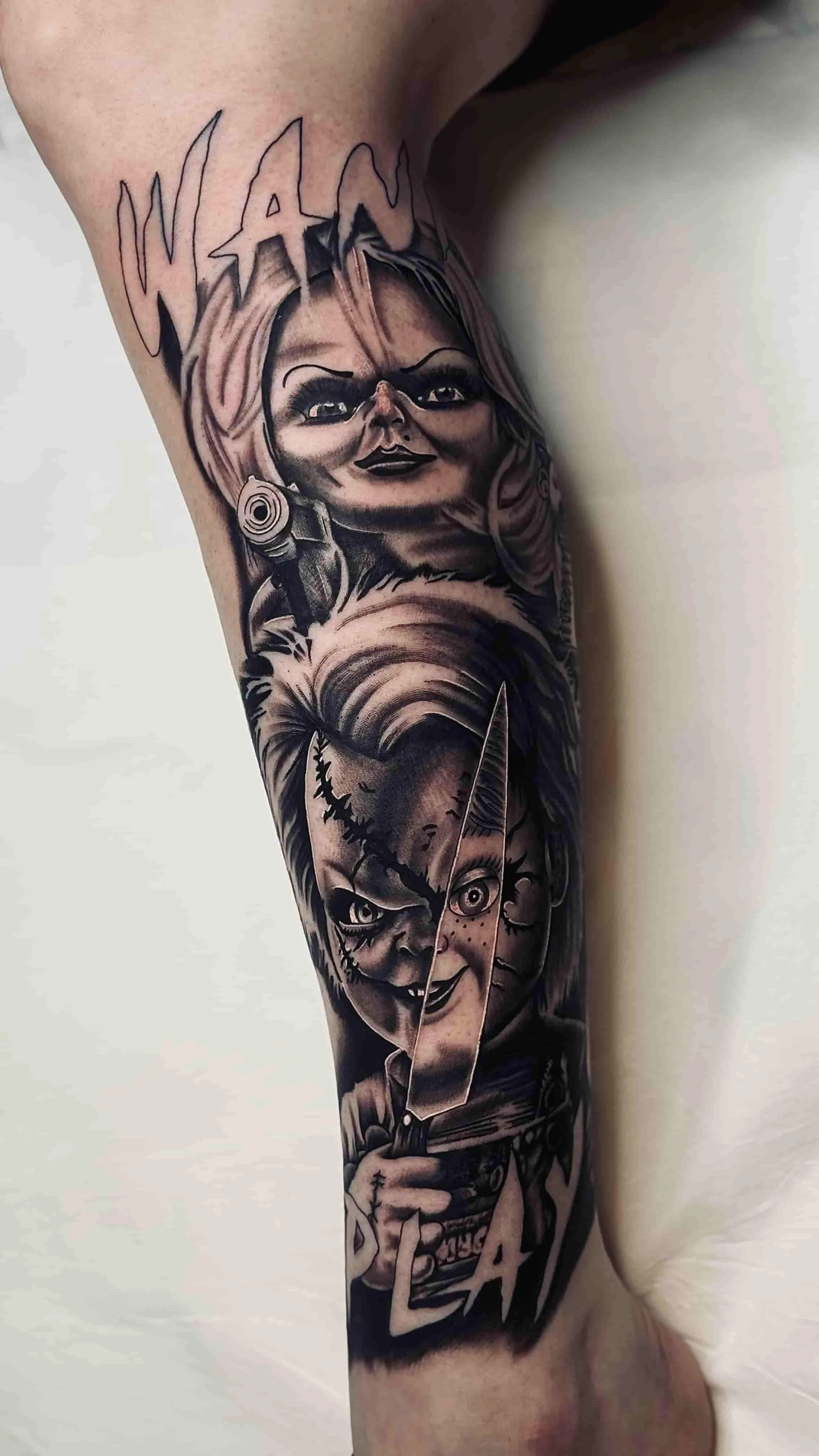 Chucky and Tiffany horror tattoo on the leg black and grey realism