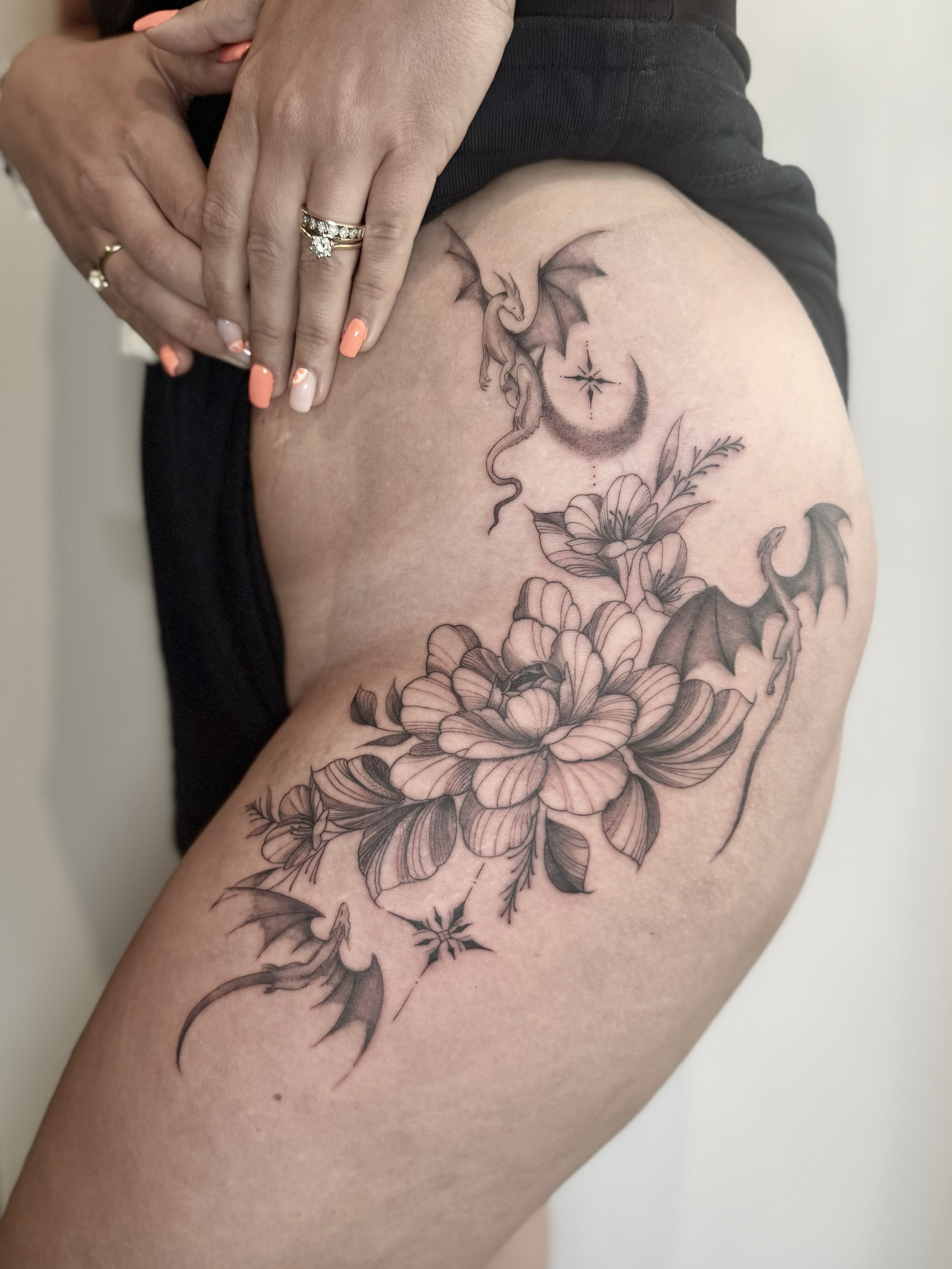 Fineline Flowers and Dragons feminine hip tattoo for women