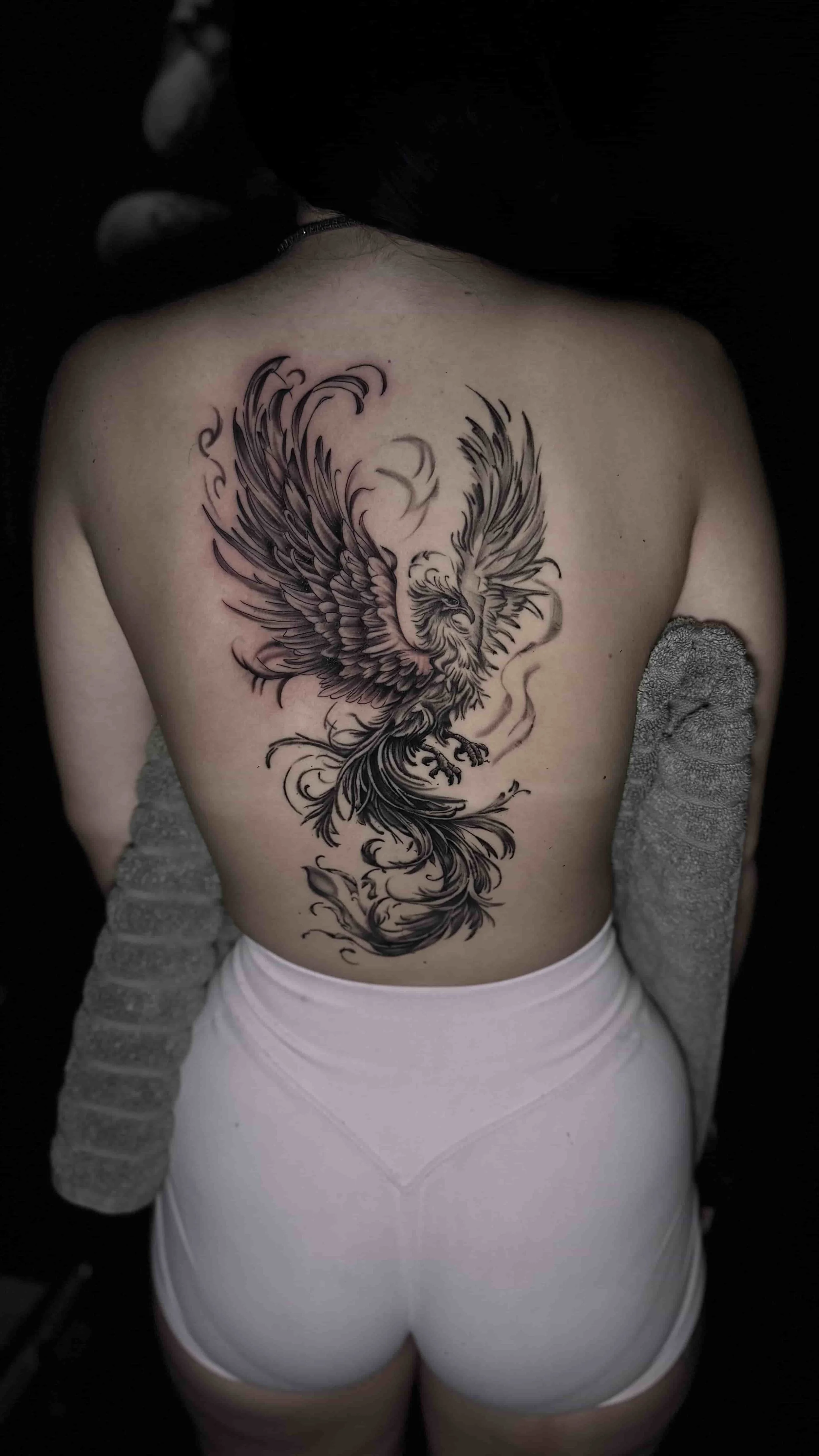 Black and grey realism phoenix tattoo on the back