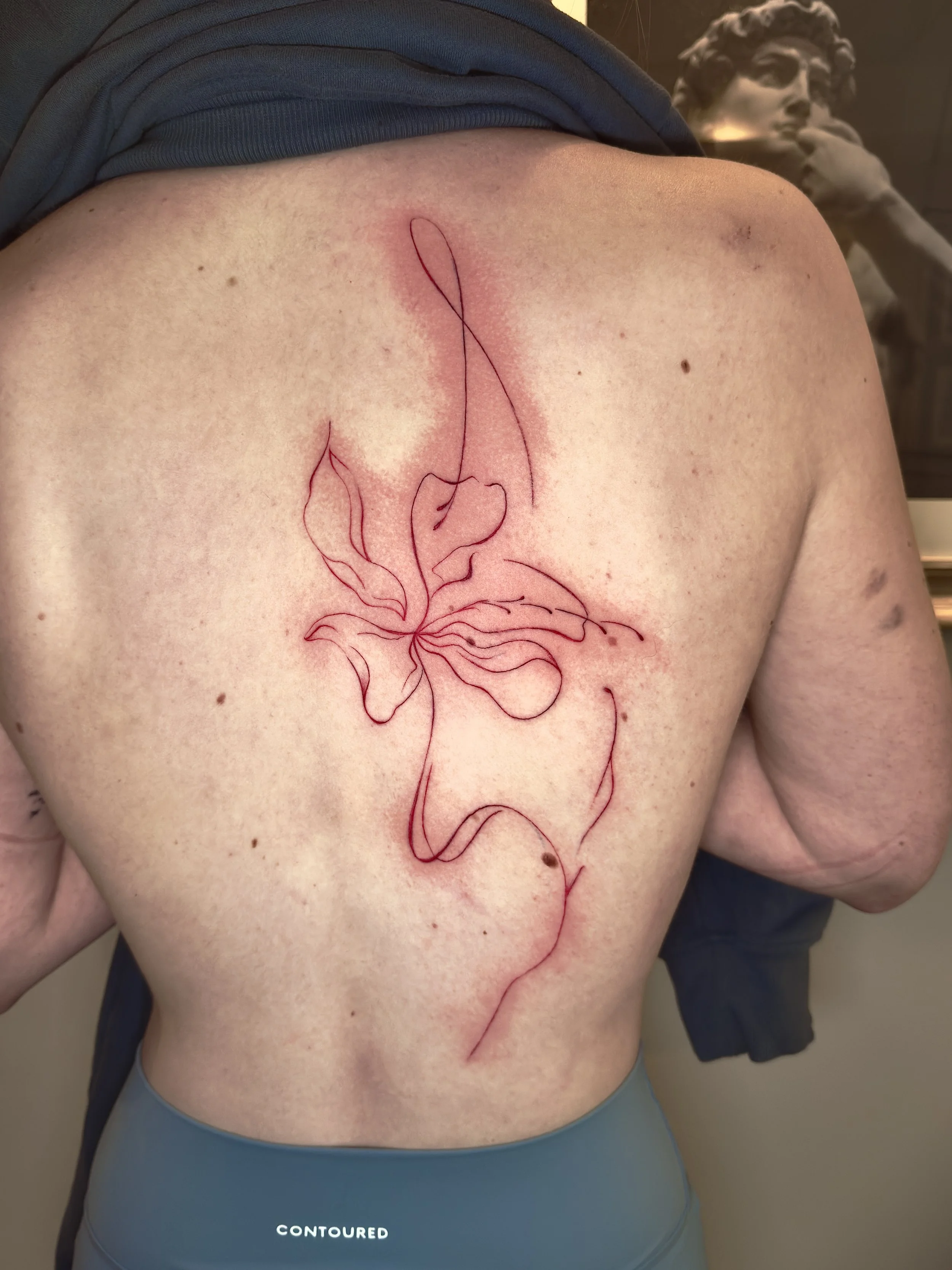 red flower back tattoo .jpg
