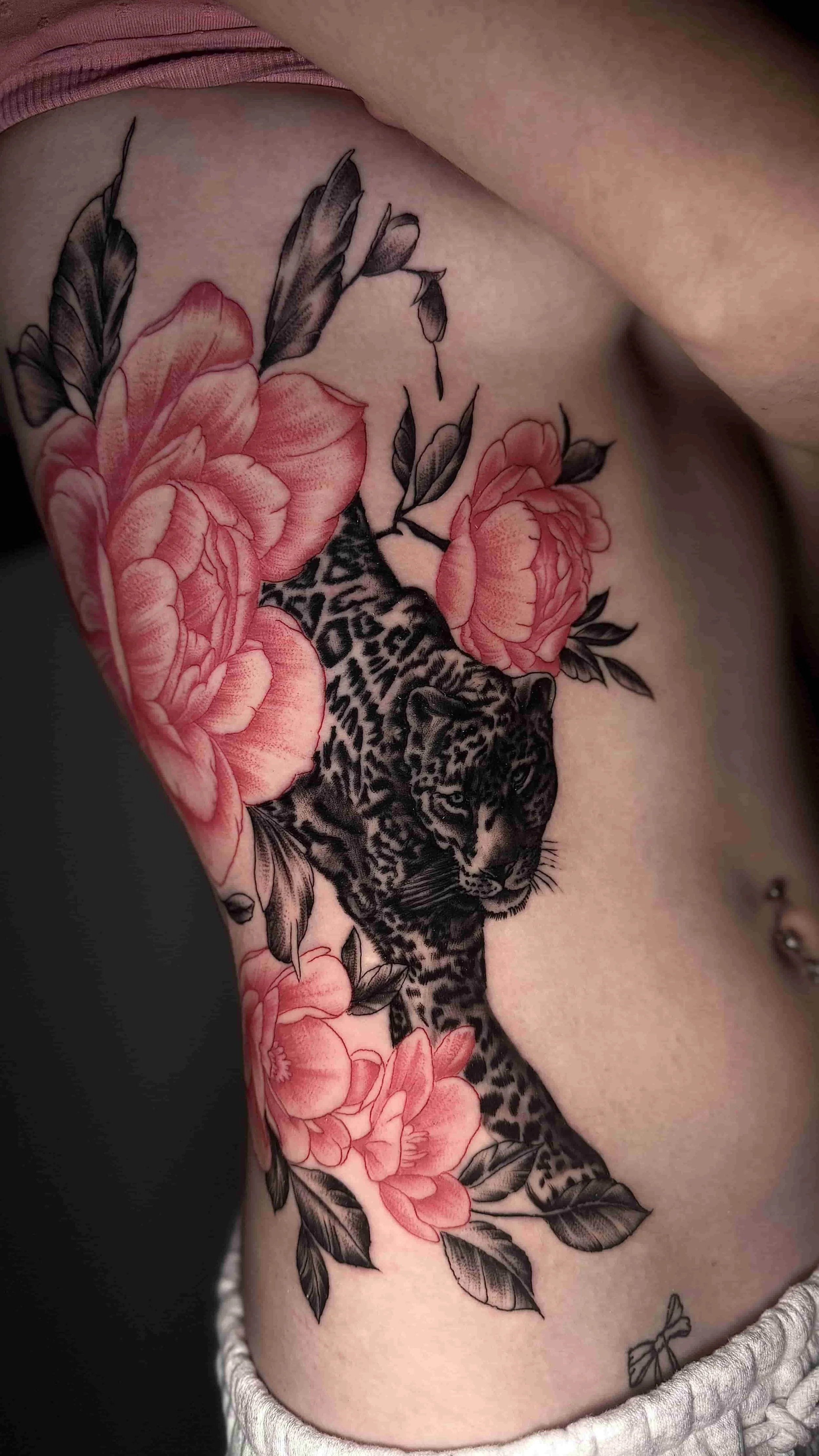 Cheetah with red flowers tattoo