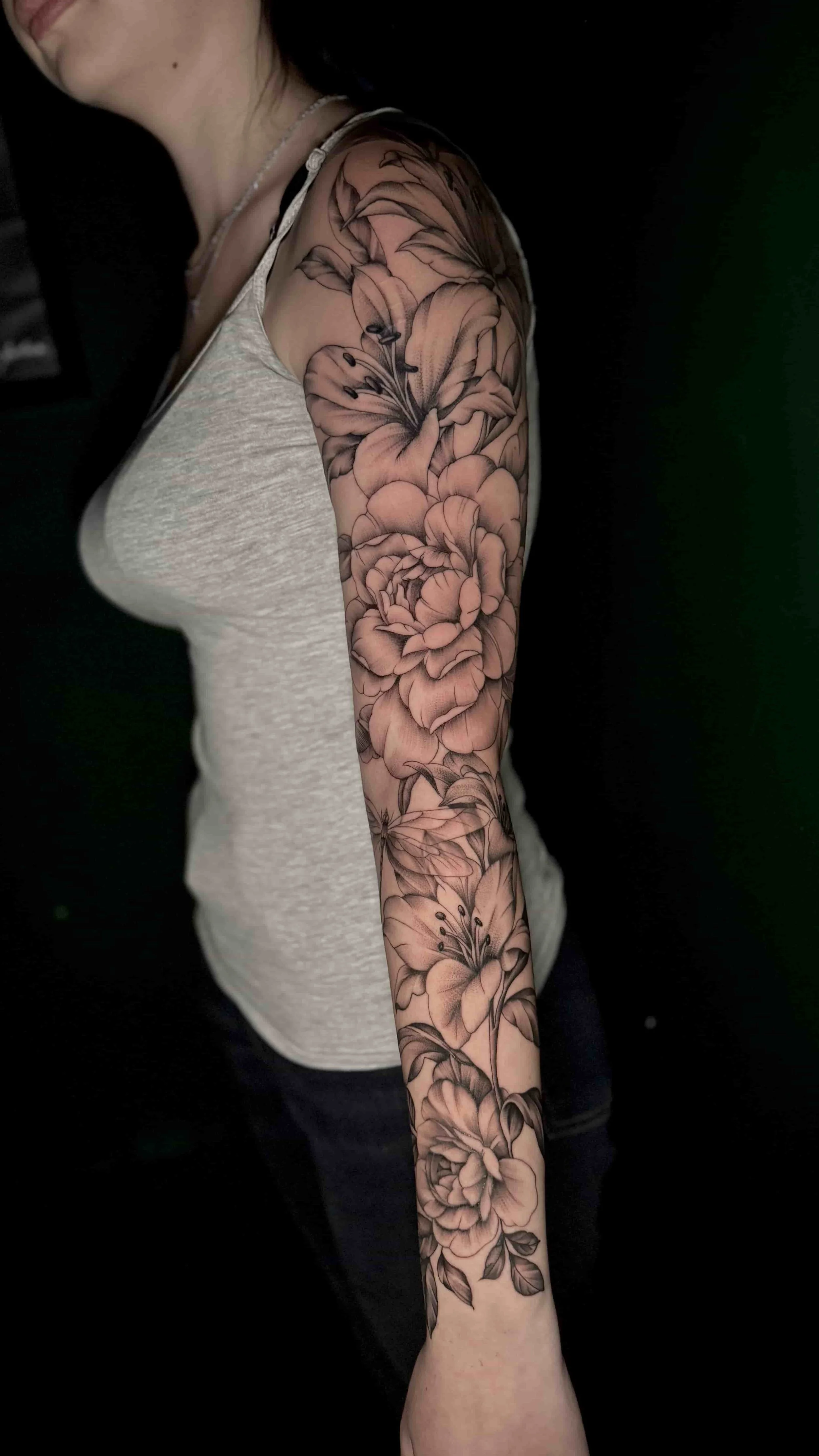 black and grey floral tattoo sleeve on woman