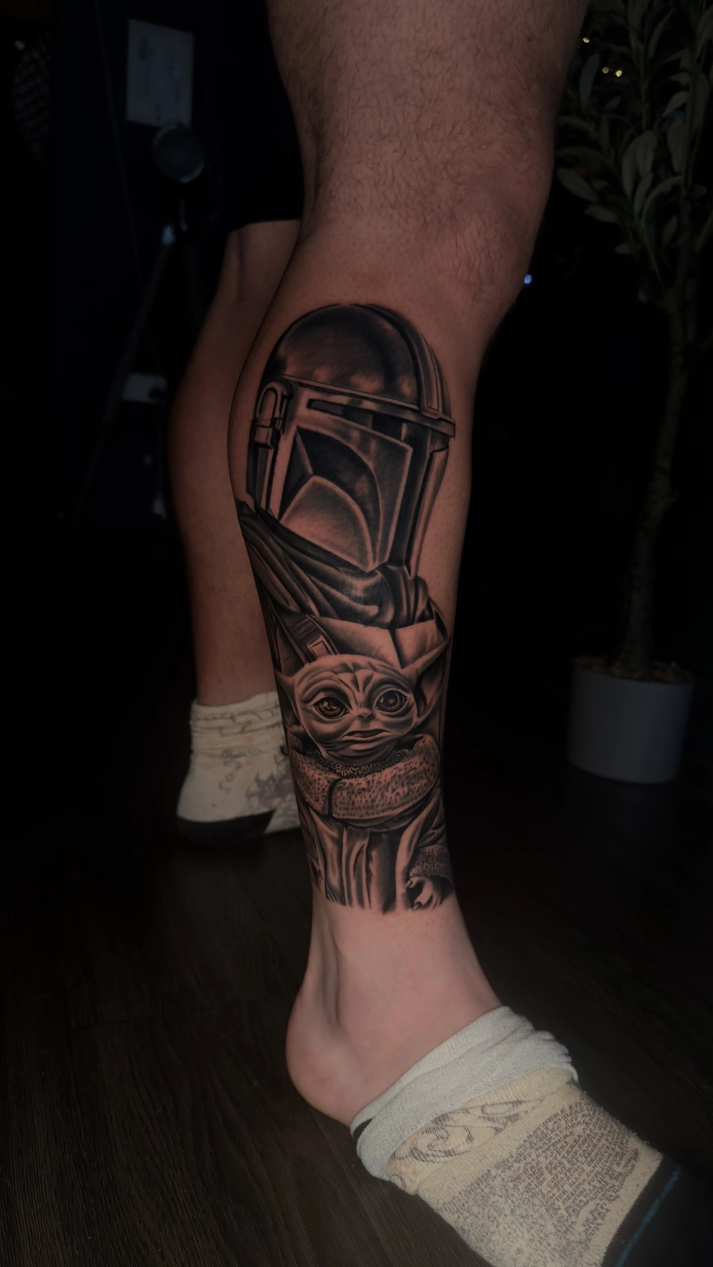 Black and grey realistic Mandalorian and Baby Yoda leg tattoo, by Harry Devlin, Devlin Ink Tattoos Colchester