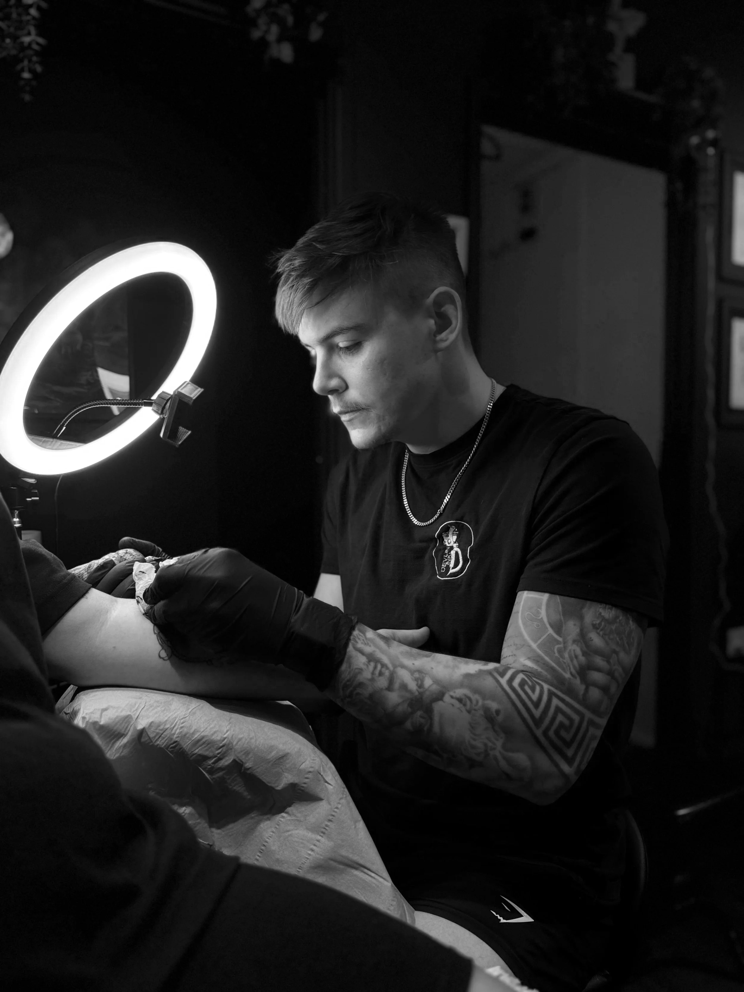 Harry Devlin tattooing a black and grey realism piece at Devlin Ink Tattoos, Colchester