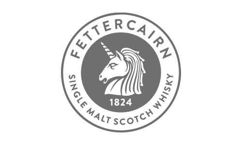 Logo for Fettercairn Single Malt Scotch Whisky, featuring a unicorn with a spiral horn inside a circular seal with the year 1824.