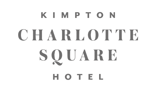 Signboard for Kimpton Charlotte Square Hotel with black background and white text