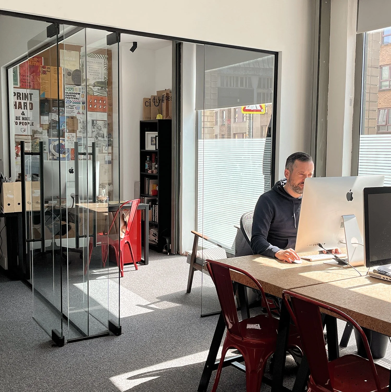 Printbox office with large windows and a frosted glass wall.