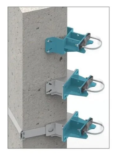 Three anchor brackets in different colors mounted on a concrete wall, each with a metal hook attached.
