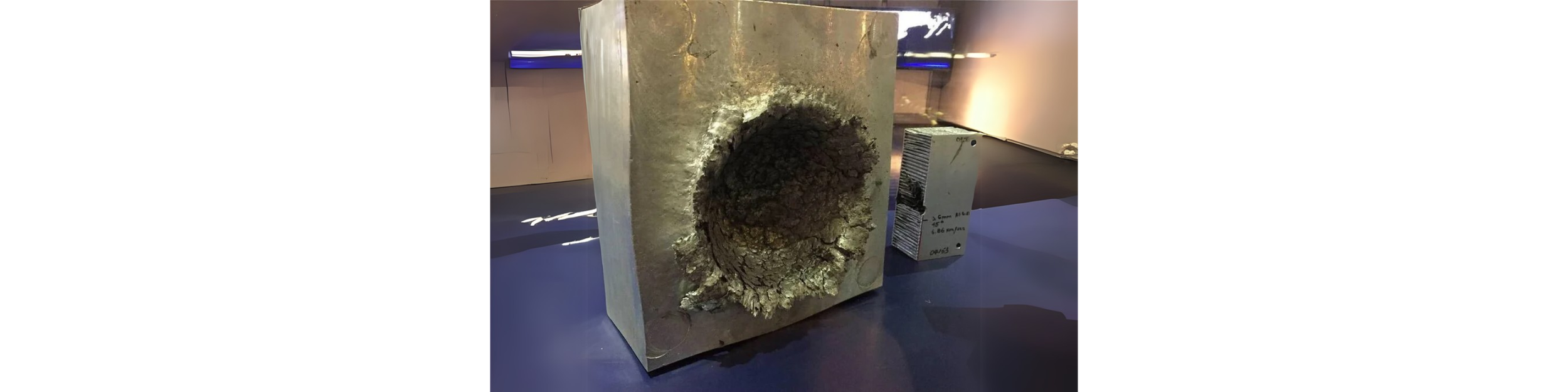  Aluminum block hit with particle at hypervelocity. 