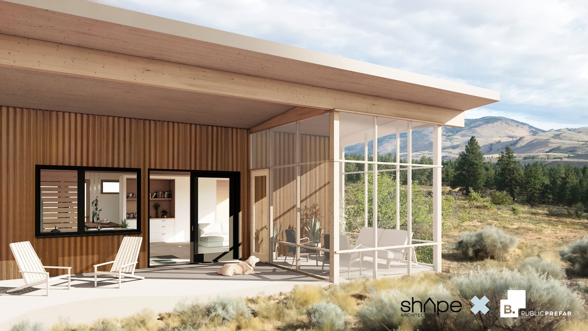 Modern house with a wooden exterior and large glass windows in a desert landscape with mountains in the background.