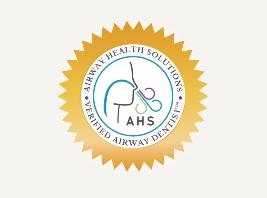 Seal with a gold starburst border and a white inner circle featuring a stylized nose and airways illustration, along with the text 'Airway Health Solutions' and 'Verified Airway Dentist' surrounding it, and the acronym 'TAHS' below.