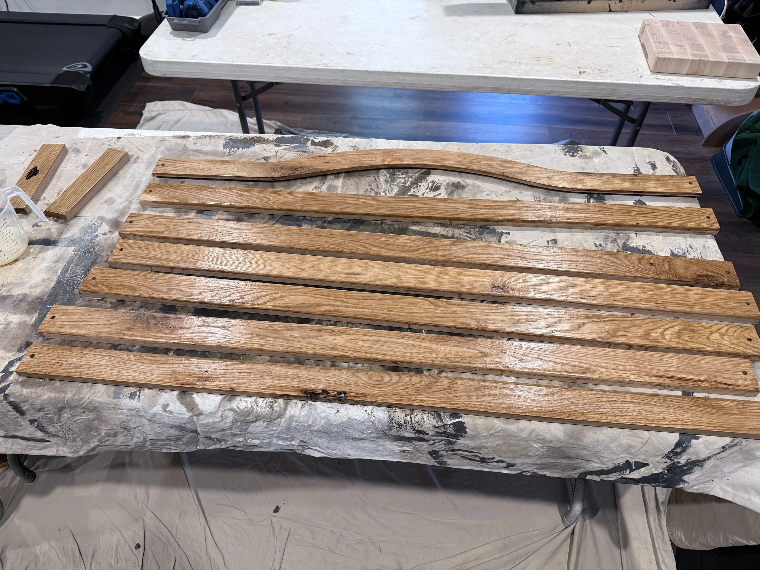 Missed a shot of cutting the pieces, but here are the new slats getting clear coat to last another 40 years.