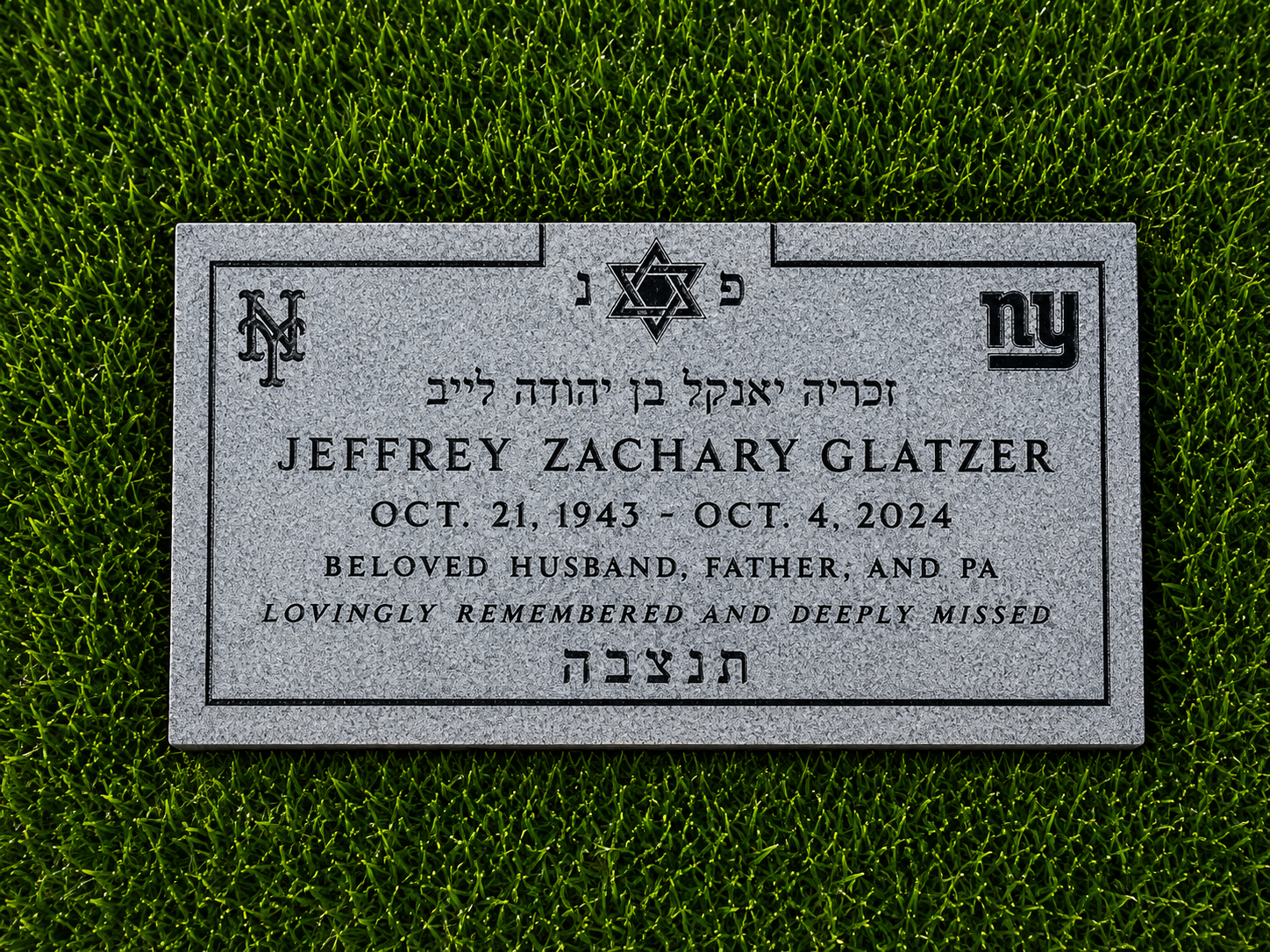 Gravestone with Star of David, Hebrew script, and the name Jeffrey Zachary Glatzer, surrounded by green grass.