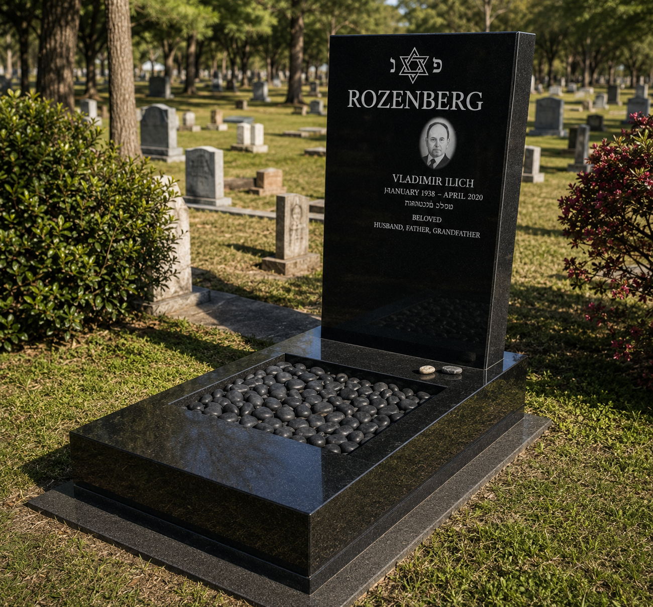 A black granite gravestone at a cemetery with engraved text, portrait, Star of David, and stones placed on it, surrounded by grass, bushes, and other gravestones under a sunny sky.