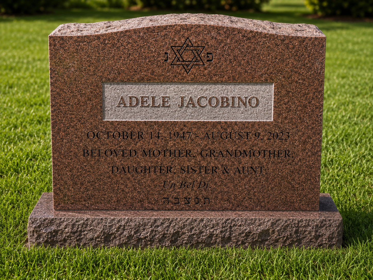 Gravestone with Star of David symbol at the top, inscribed with the name Adele Jacobino, with dates October 14, 1947 to August 9, 2023, and the words loved mother, grandmother, daughter, sister, and aunt, along with Hebrew text.