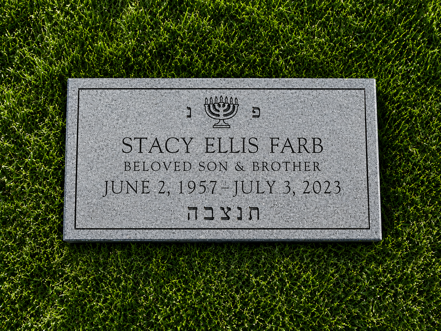 Gravestone for Stacy Ellis Farb with inscription including her dates and a menorah symbol, surrounded by green grass.