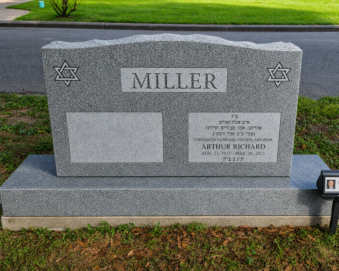 Gravestone with the name Miller, Star of David symbols on both sides, inscriptions in Hebrew and English, mentioning Arthur Richard (born August 23, 1937, died March 18, 2023), with a small photograph on a stand nearby.