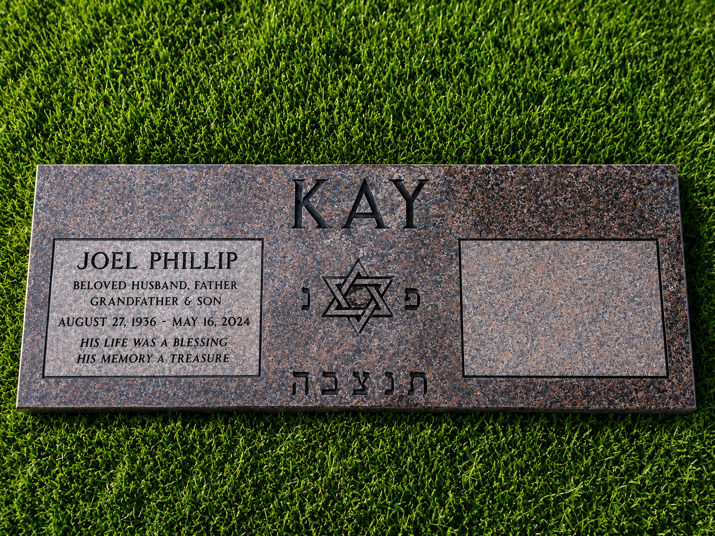 Gravestone with the name and dates of Joel Phillip, surrounded by green grass, with a Star of David symbol between the name Kay and the Hebrew inscription.