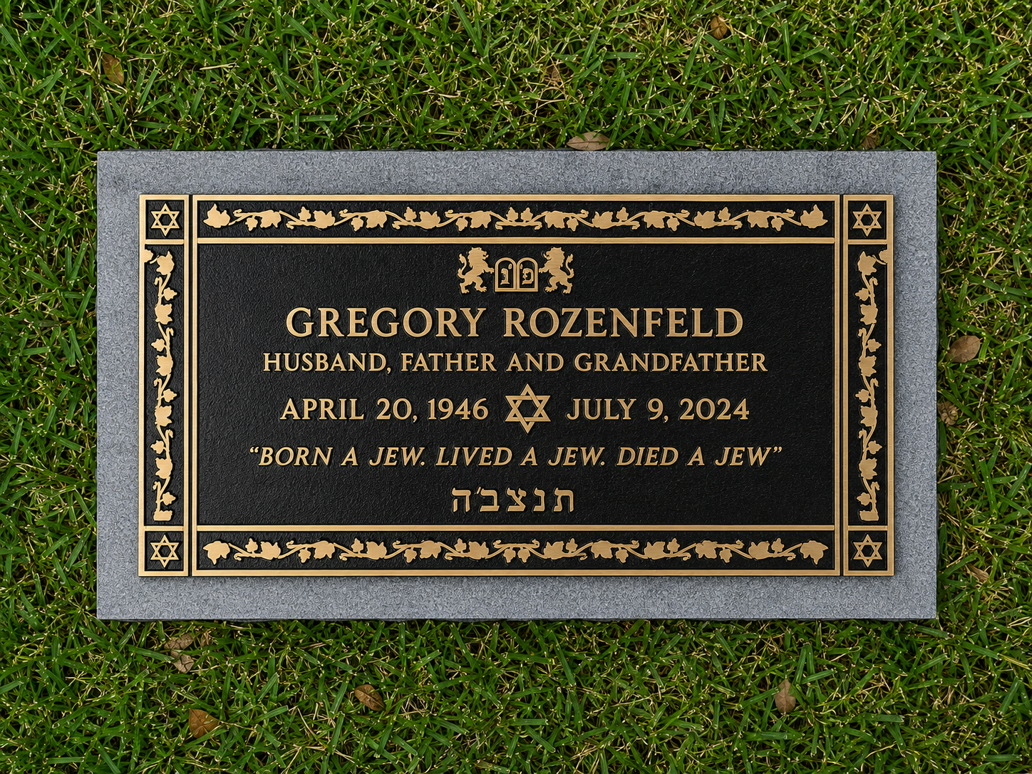 Gravestone for Gregory Rozenfeld, displaying his birth and death dates, along with a Jewish phrase and symbols, on a grassy area.