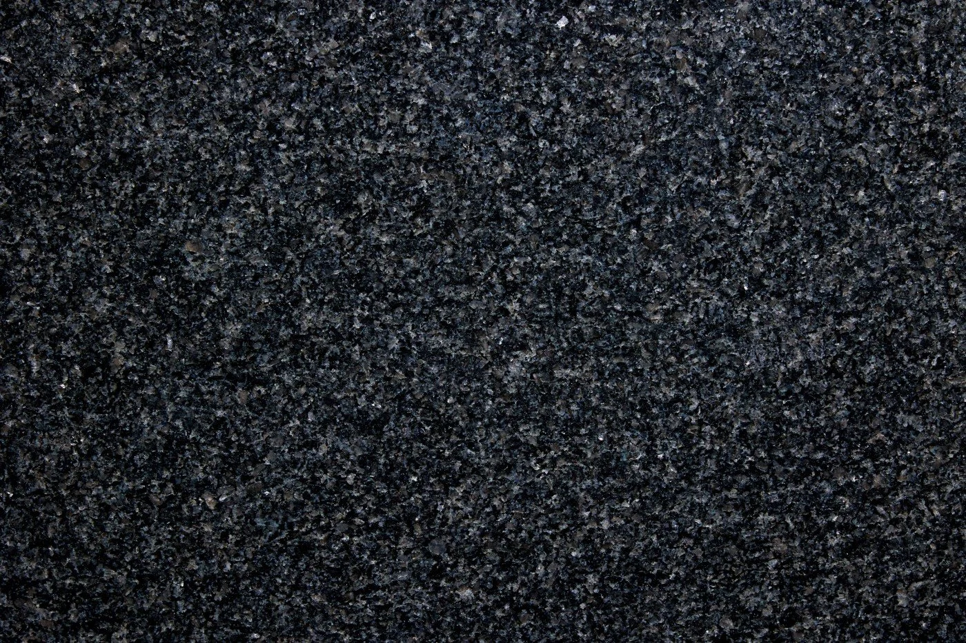 Close-up of black textured gravel or asphalt surface.
