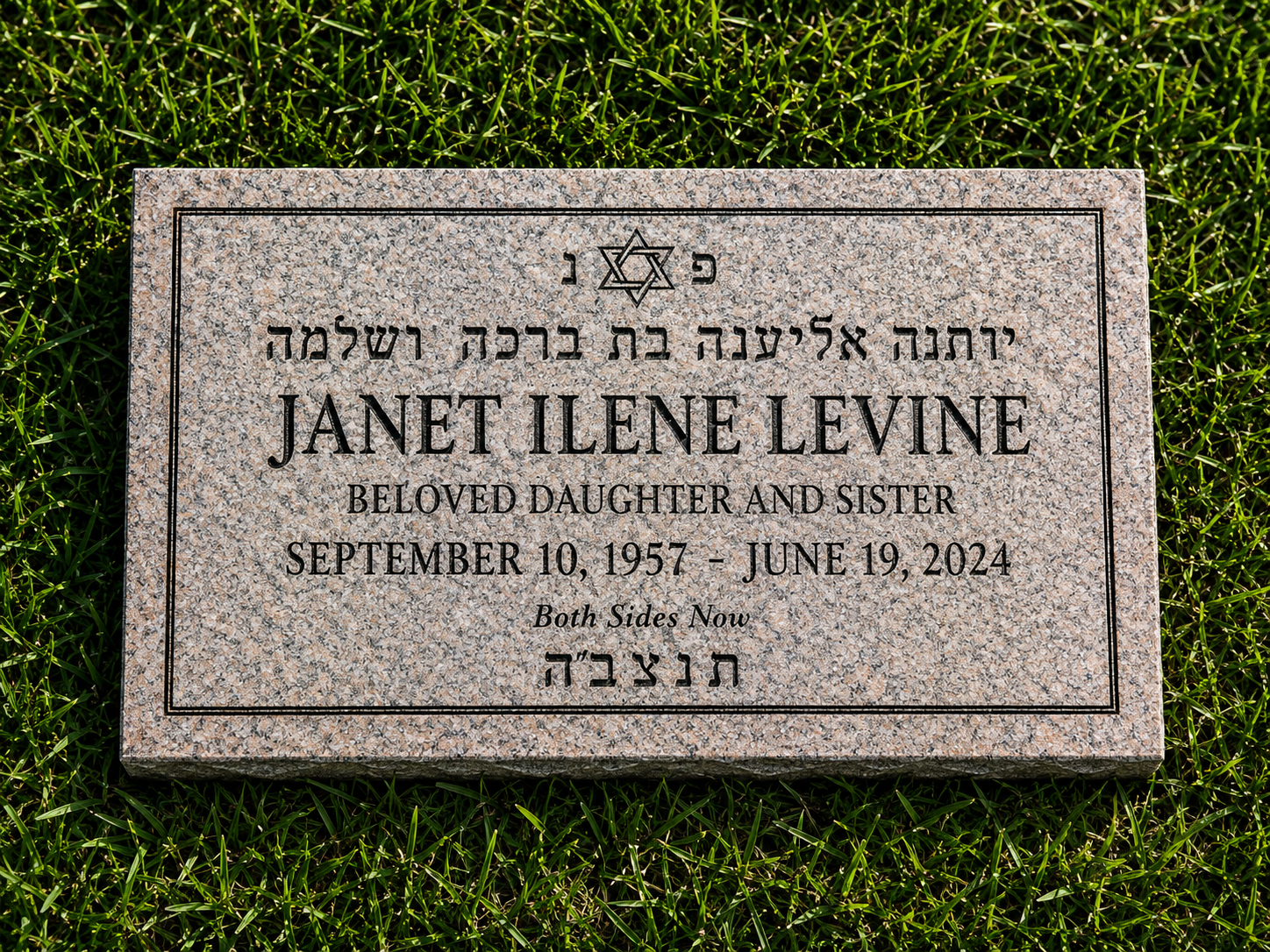 Gravestone for Janet Ilene Levine, who was born on September 10, 1957, and died on June 19, 2024, with Hebrew inscriptions and a Star of David at the top, set on grass.