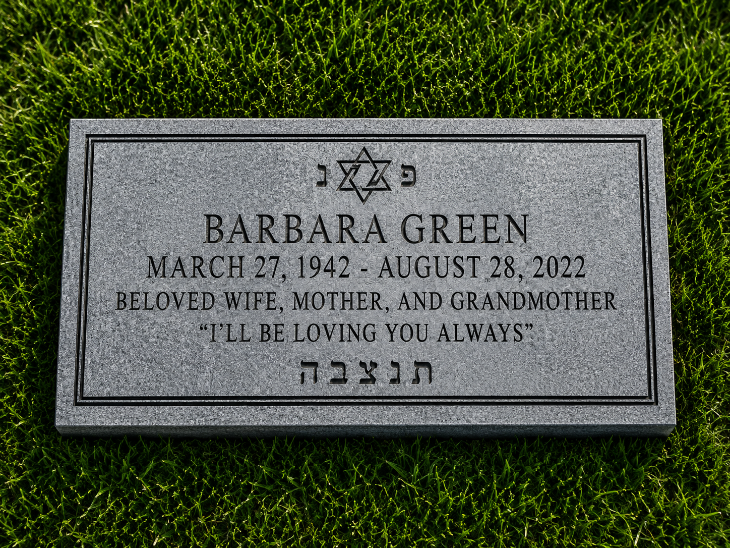 Gravestone memorial plaque for Barbara Green with her birth and death dates, a Star of David, and Hebrew inscription, on grass.