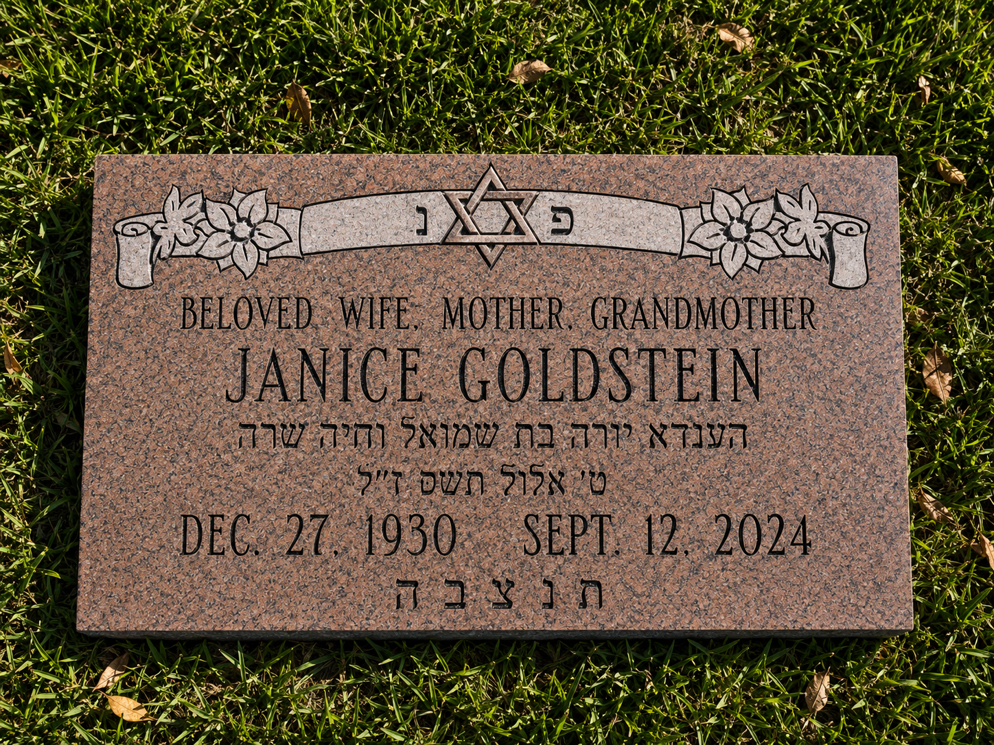 Gravestone with Star of David, depicting the name Janice Goldstein, date of birth December 27, 1930, and date of passing September 12, 2024, surrounded by grass.