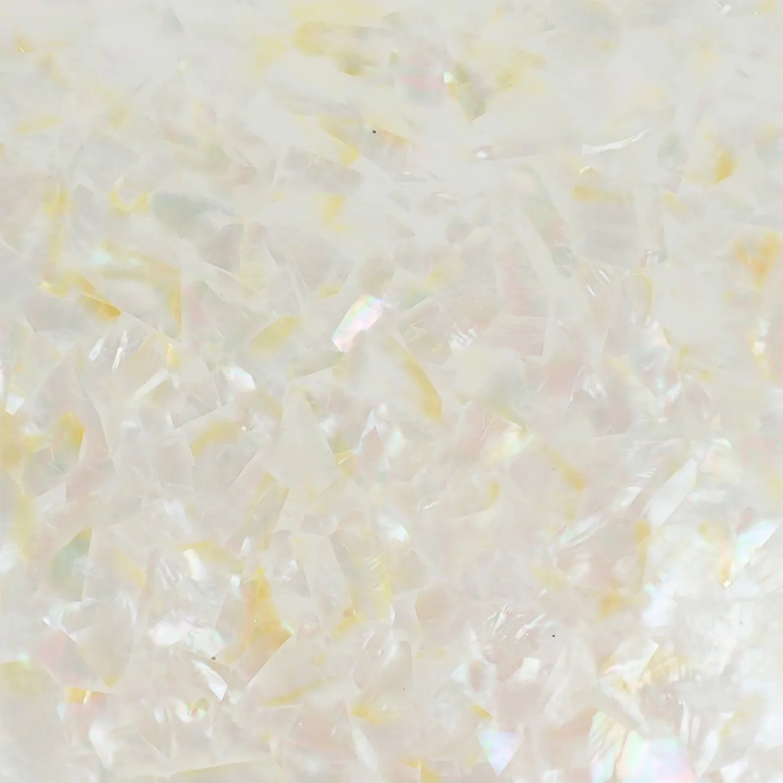 Close-up of iridescent, translucent, irregular-shaped plastic or crystal fragments.